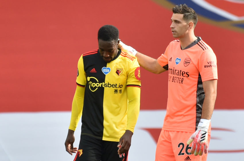 Watford's English striker Danny Welbeck (L) is consoled by Arsenal's Argentinian goalkeeper Emiliano Martinez after losing the English Premier League football match between Arsenal and Watford at the Emirates Stadium in London on July 26, 2020. (Photo by Rui Vieira / POOL / AFP) / RESTRICTED TO EDITORIAL USE. No use with unauthorized audio, video, data, fixture lists, club/league logos or 'live' services. Online in-match use limited to 120 images. An additional 40 images may be used in extra time. No video emulation. Social media in-match use limited to 120 images. An additional 40 images may be used in extra time. No use in betting publications, games or single club/league/player publications. / (Photo by RUI VIEIRA/POOL/AFP via Getty Images)