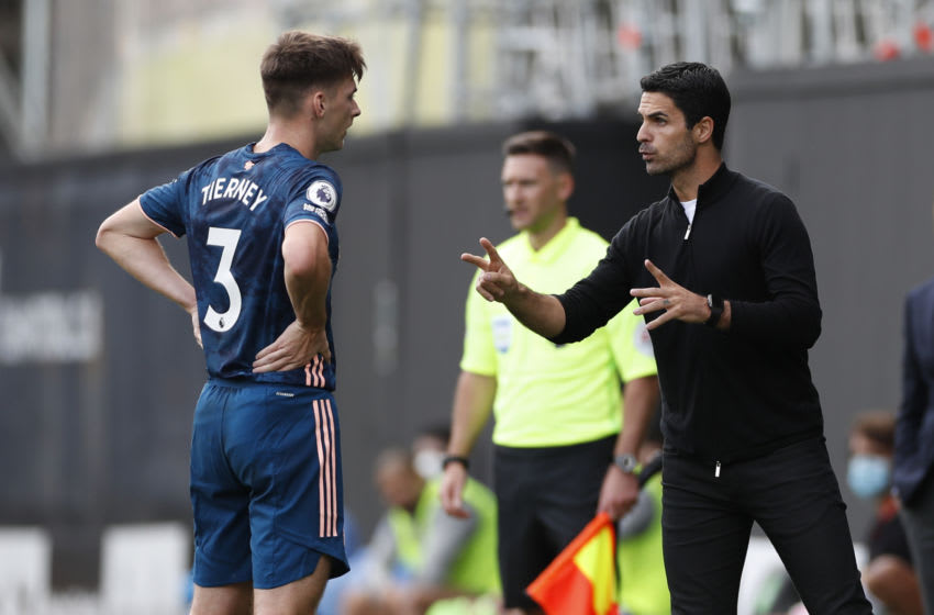 Arsenal's Spanish first-team manager Mikel Arteta (R) talks with Arsenal's Scottish defender Kieran Tierney (L) on the touchline during the English Premier League football match between Fulham and Arsenal at Craven Cottage in London on September 12, 2020. (Photo by PAUL CHILDS / POOL / AFP) / RESTRICTED TO EDITORIAL USE. No use with unauthorized audio, video, data, fixture lists, club/league logos or 'live' services. Online in-match use limited to 120 images. An additional 40 images may be used in extra time. No video emulation. Social media in-match use limited to 120 images. An additional 40 images may be used in extra time. No use in betting publications, games or single club/league/player publications. / (Photo by PAUL CHILDS/POOL/AFP via Getty Images)