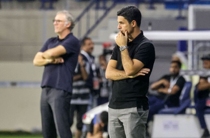 Arsenal's Spanish manager Mikel Arteta (R) and Lyon's French head coach Laurent Blanc (L) watch from the sidelines during the Dubai Super Cup 2022 match between Arsenal and Olympique Lyonnais at al-Maktoum stadium in Dubai on December 8, 2022. (Photo by KARIM SAHIB / AFP) (Photo by KARIM SAHIB/AFP via Getty Images)