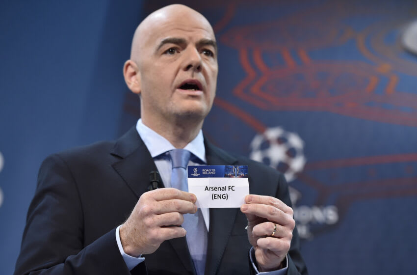 UEFA General Secretary Gianni Infantino shows the name of Arsenal football club during the draw for the UEFA Champions league round of sixteen, on December 14, 2015 at the UEFA headquarters in Nyon. AFP PHOTO / FABRICE COFFRINI / AFP / FABRICE COFFRINI (Photo credit should read FABRICE COFFRINI/AFP via Getty Images)