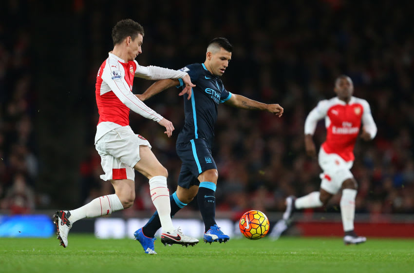 LONDON, ENGLAND - DECEMBER 21: Laurent Koscielny of Arsenal tackles Sergio Aguero of Manchester City during the Barclays Premier League match between Arsenal and Manchester City at the Emirates Stadium on December 21, 2015 in London, England. (Photo by Catherine Ivill - AMA/Getty Images)
